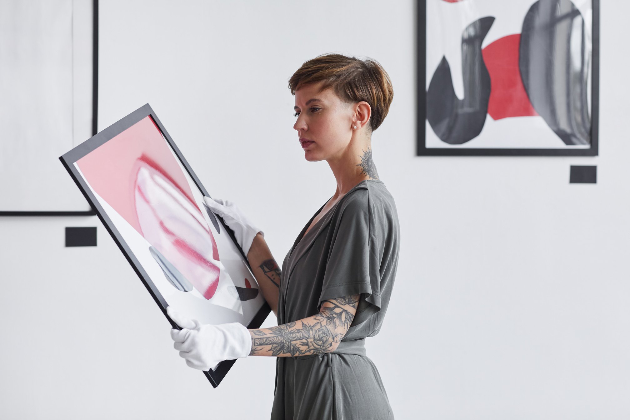 Creative Woman Holding Painting in Art Gallery